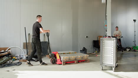 worker handling battery pack in a workshop