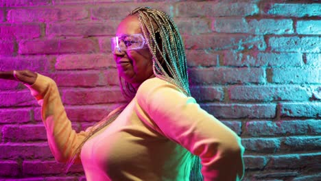 happy senior african woman dancing and wearing futuristic augmented reality glasses