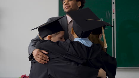 Happy-Miltiracial-Students-Hugging-Their-Teacher