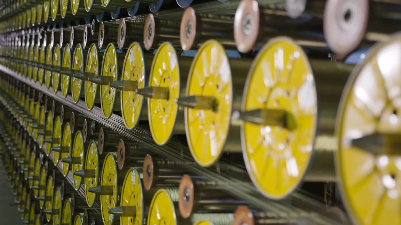 Camera Moves Aside from Bobbins Coiling Threads Closeup