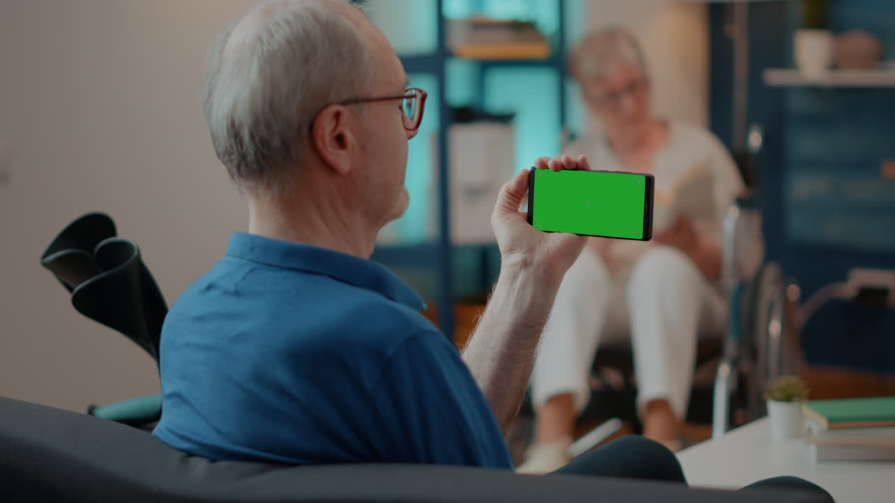 Elderly Man Using Smartphone with Green Screen