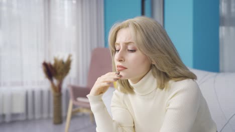 the young woman who looks pessimistic, thoughtful and worried is unhappy.