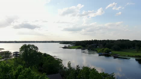 rising out of lake side park to reveal beautiful sunset views over florida lake