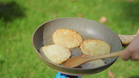 potato pancakes baking in a pan with oil outside during the summer-1