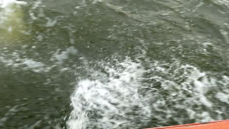 side wake of boat cruising along the chao phraya river in bangkok, thailand