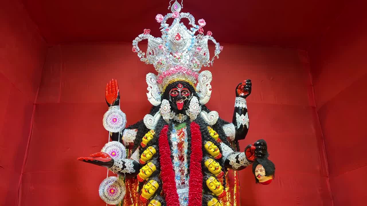 Kali Maa idol in traditional look in red background