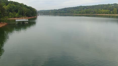 Very-low-altitude-aerial-view-of-flight-above-lake-ending-with-focus-on-fishermen