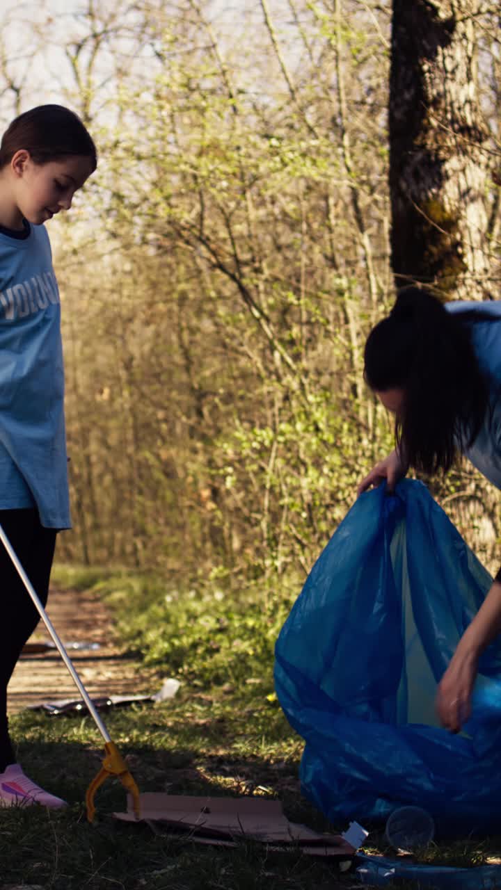 Volunteers Cleaning Up Litter in a Park with Trash Pickers