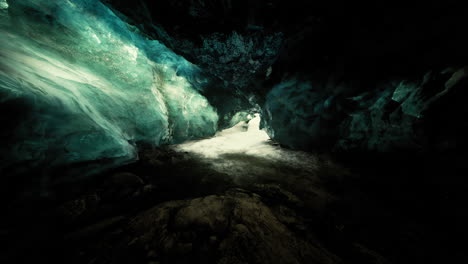 blue ice cave covered with snow and flooded with light