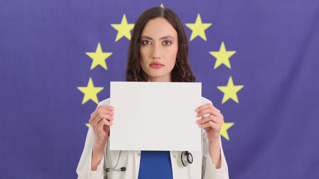 Female Doctor Holding Blank Sign in Front of European Union Flag