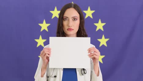 female doctor holding blank sign in front of european union flag