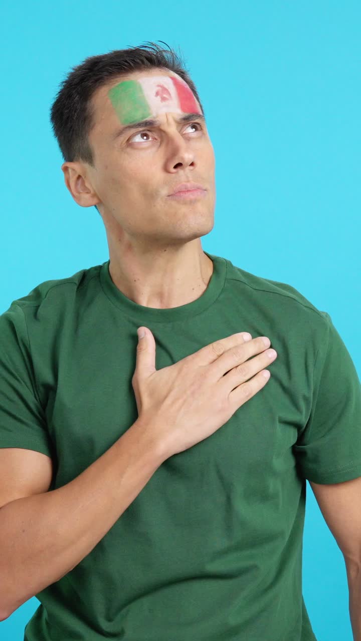 Man listening to the Mexico national anthem with solemnity