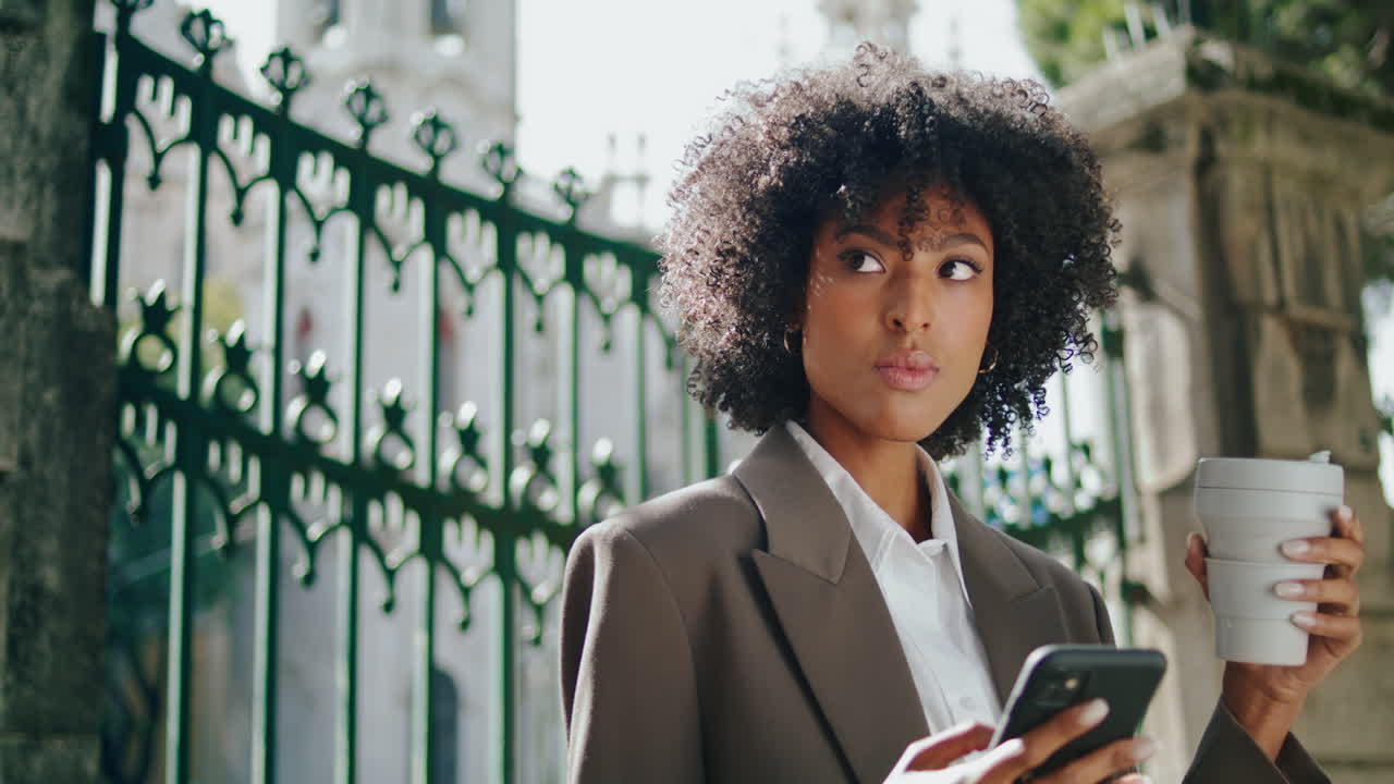 Business lady talking phone with coffee cup outdoors close up. Confident woman
