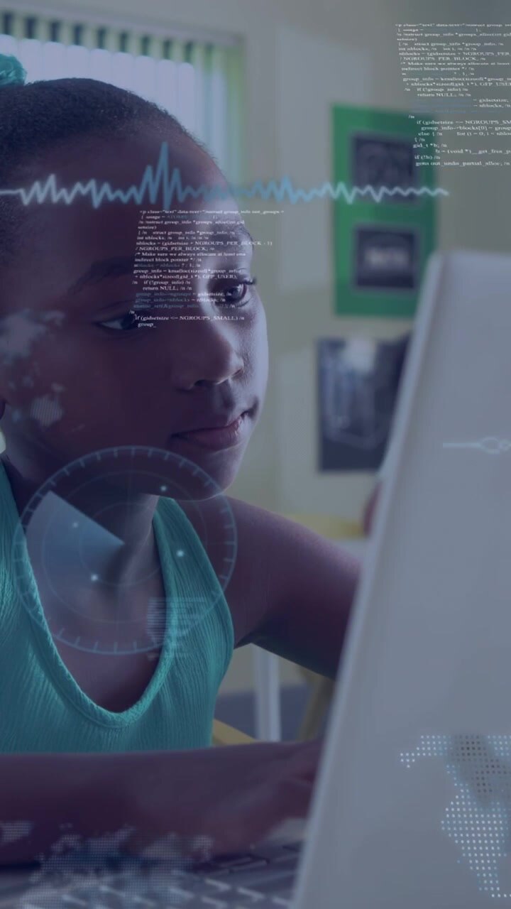 Vertical video: Female student typing, initiating HUD overlays on laptop and face, learning code