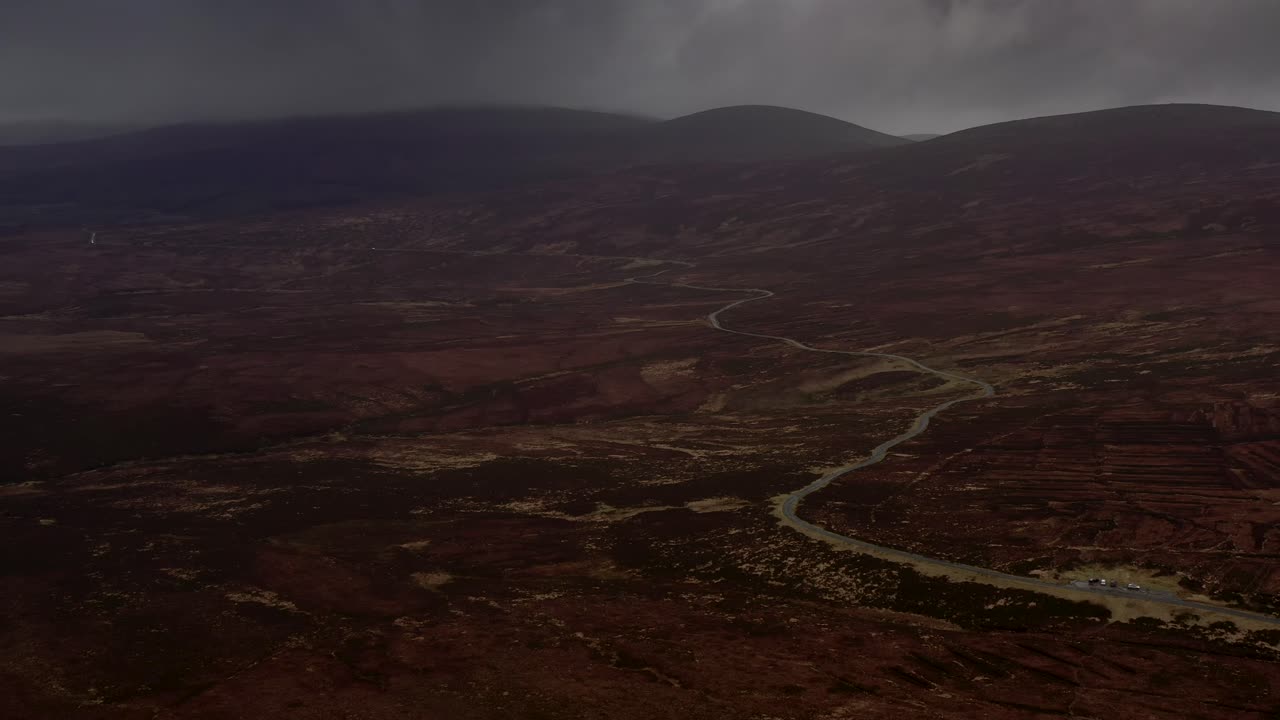 Spectacular Aerial view of Sally Gap, Wicklow Mountains, Ireland, February 2020. Drone pushes forward slowly over the Old Military Road crossing the peat bog landscape.