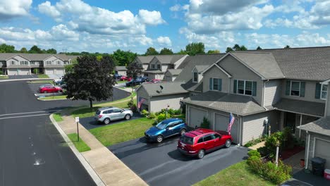 american flags waving on duplex houses in america