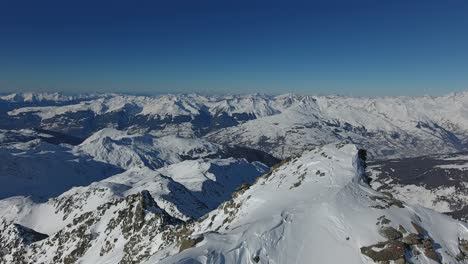 Volando-A-Lo-Largo-De-La-Cresta-De-La-Montaña-En-Los-Alpes-Franceses.-Toma-Aérea-Soleada