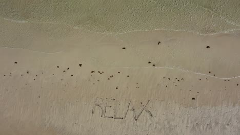 peace inscribed the sand on a beach shot at an angle