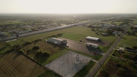 Aerial-over-residential-area-and-highway-road-with-traffic-on-it