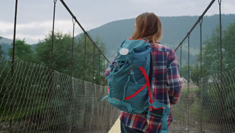 girl enjoying mountain hitchhike on summer nature landscape. woman walk outside.