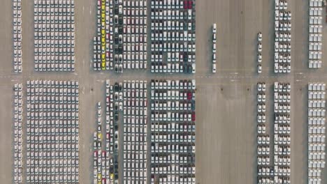 aerial view of large parking new cars distribution center of modern seaport.