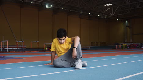 boy resting in running track