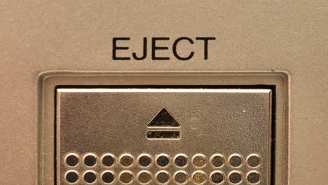 extreme close up of buttons on an old antique or vintage vcr pushing the eject button