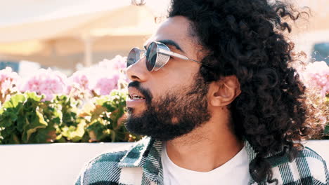 stylish man with curly hair and sunglasses
