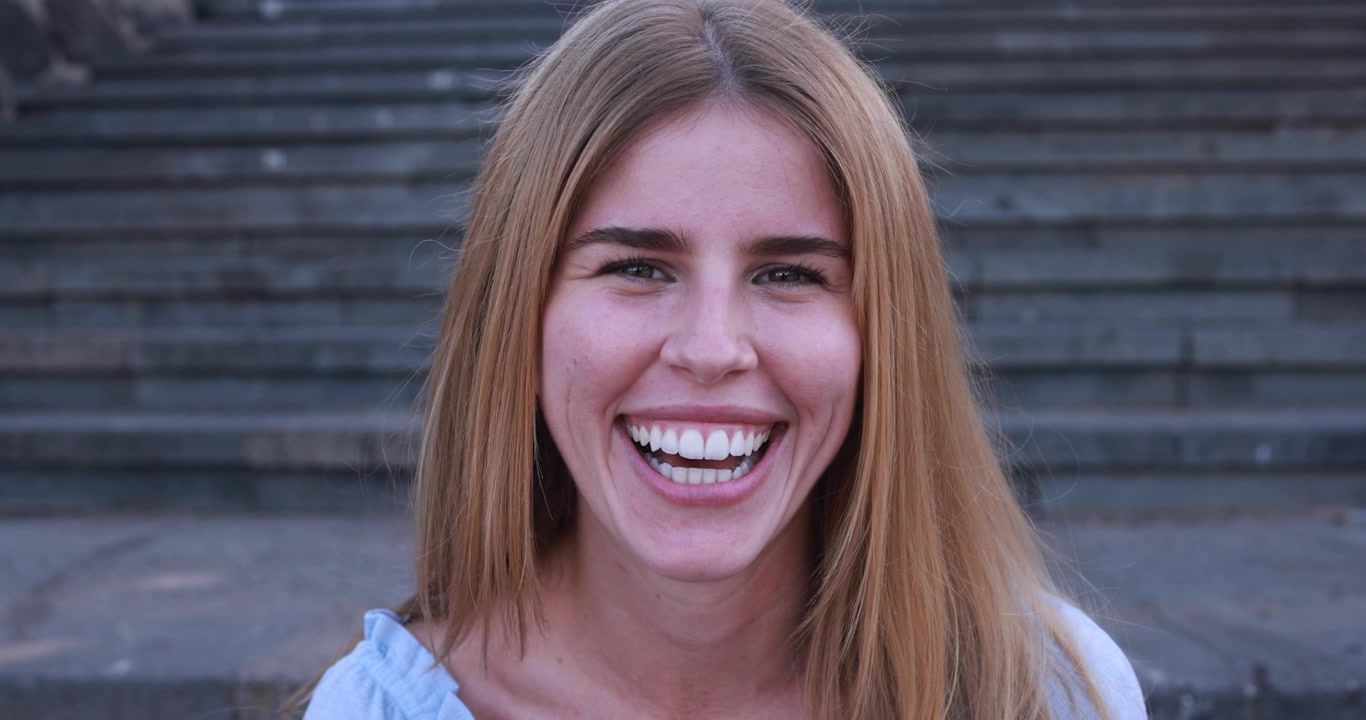 Close Up Portrait of a Happy Young Woman Smiling