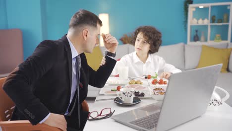 sad single businessman having breakfast with his son in the morning.