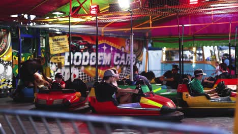 people enjoying bumper cars at a carnival