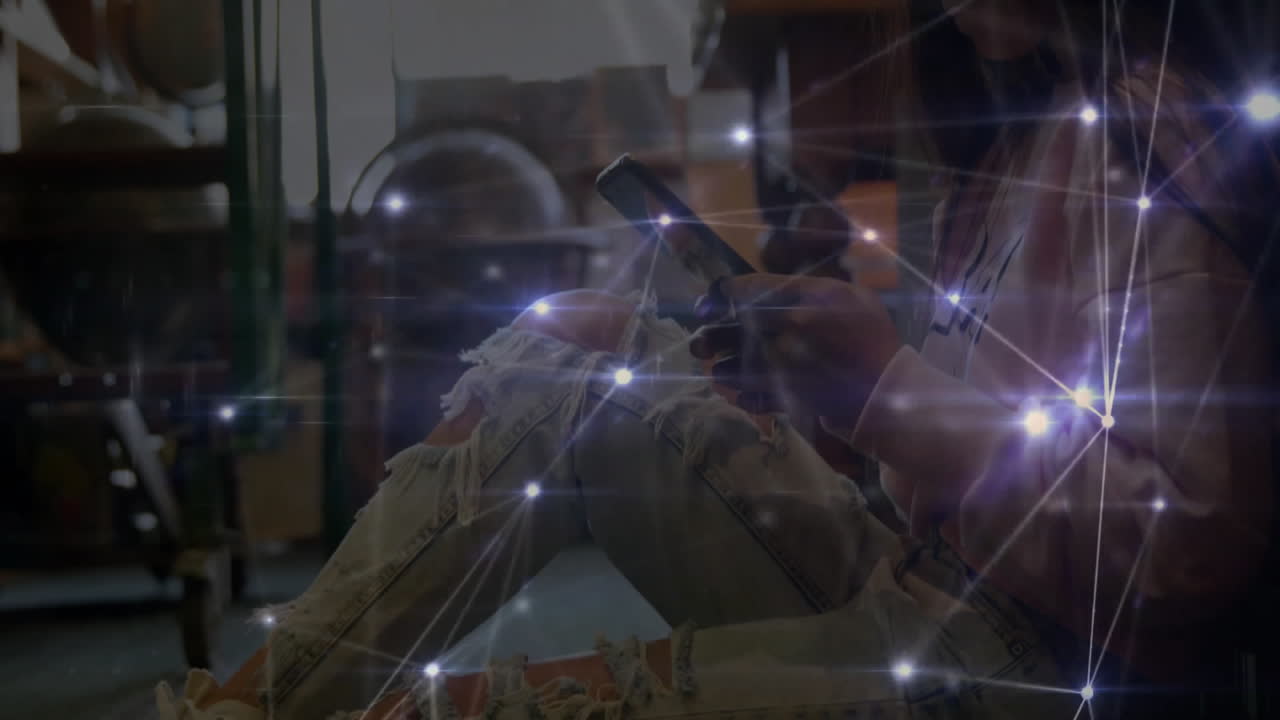 woman using smartphone on warehouse floor, showing glowing technology connectivity overlay