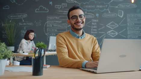 man working on laptop in a modern office