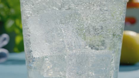 ice cubes and bubbles in sparkling clear beverage