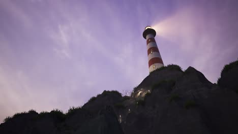 beam of light from lighthouse rotating over the sea during sunset. tall tower on the small island. the building serves as a navigational aid for maritime pilots during night time. loopable animation.