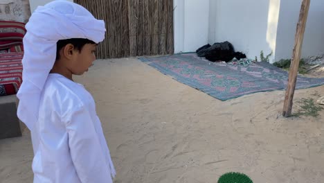 arab child in traditional outfit kandura talking