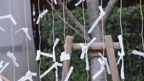 paper notes hanging on small rope during new years day celebration in japan at yasaka shrine in kyoto