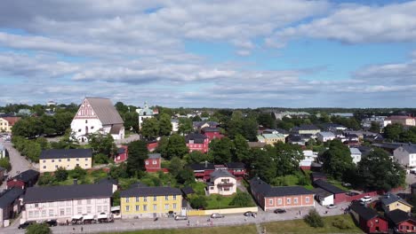 aerial pan shot over historic town of porvoo in finland during sunny day showing beautiful buildings and trees