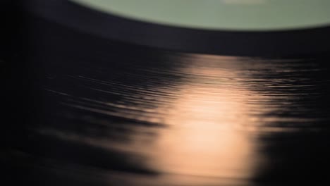 close up, macro shot of old vinyl disc spinning on a record player