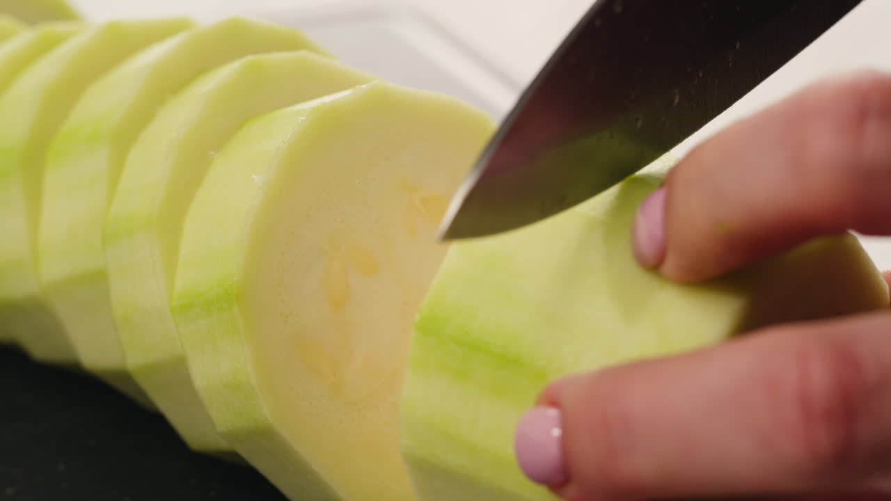 Cutting zucchini with knife