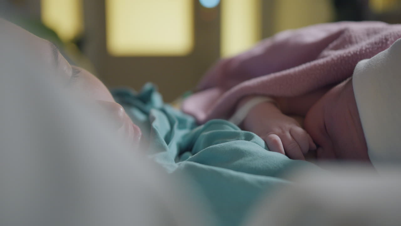 Mother nurses newborn baby placed on the chest directly after birth, close up 4k video footage