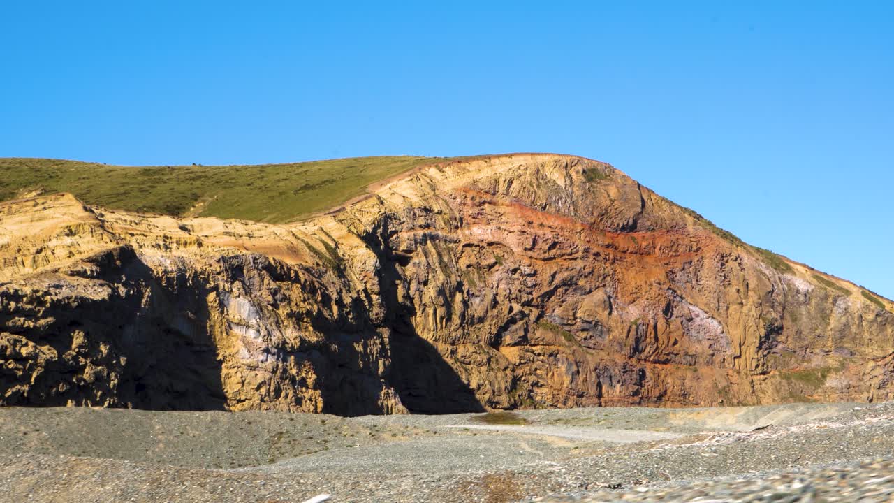 Sunset on seaside cliffs and sea waves