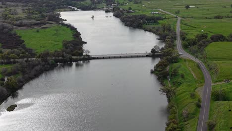 A sweeping drone shot captures the Merced Bridge, illustrating its sturdy construction over the river’s path.
