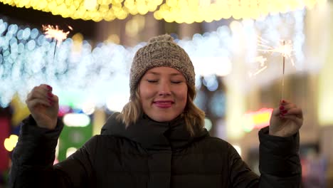 woman celebrating with sparkler at night