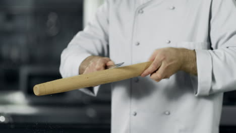 man chef cleaning up roller at workplace. closeup man hands preparing to cook.