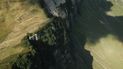 drone aerial view of a mountain ridge on the diedamskopf (mountain in austria) in sunny weather. the mountain station of the cable car is visible in the background after the pan.