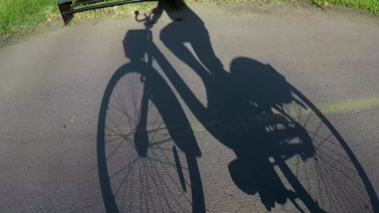 Shadow of cyclist riding the bike.Right to left direction.