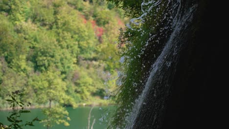 Beautiful-slow-motion-shot-of-small-forest-waterfall-splashing-over-cascade-of-rocks