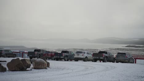 Vehicles-in-front-of-fresh-snow-in-northern-canada