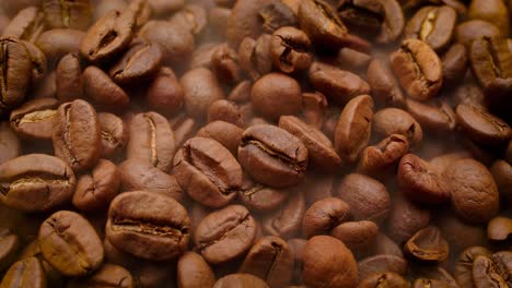 Close-up-of-seeds-of-coffee.-Fragrant-coffee-beans-are-roasted-smoke-comes-from-coffee-beans.